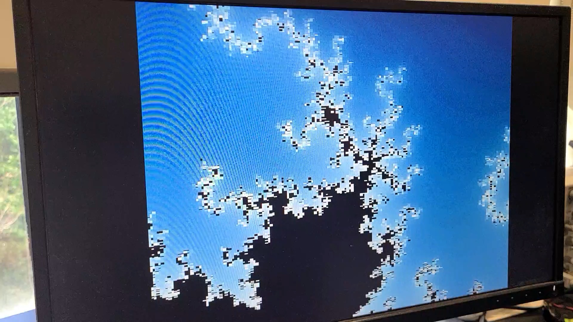 A zoomed-in rendering of the Mandelbrot set appearing very pixelated due to floating point imprecision.